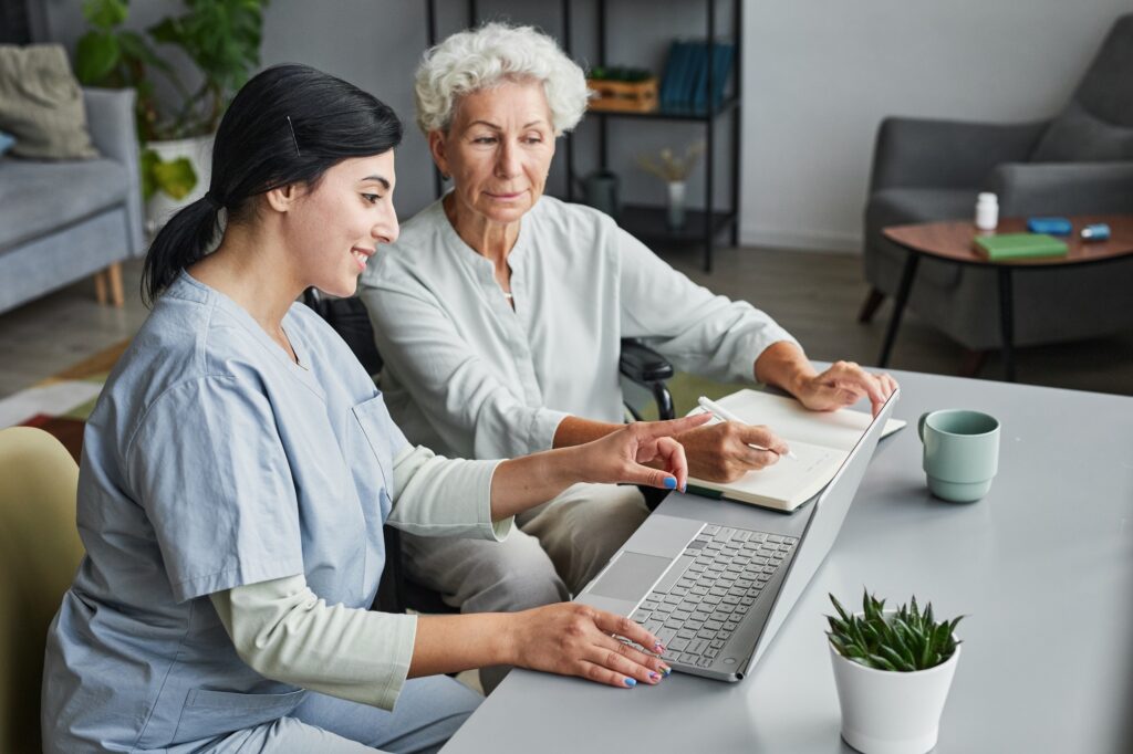 Home Caregiver Helping Senior Woman